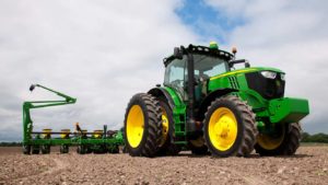 Big green tractor in the field