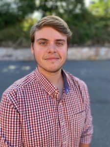 young man in red and blue plaid shirt