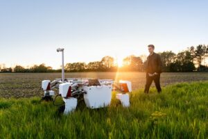 ale mechanical engineer with sustainabMale agricultural robot in field