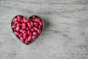 pomegranates in heart shaped bowl