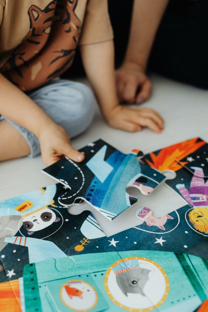 child's hand placing puzzle piece into place