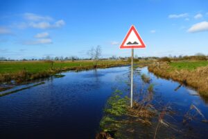 flooded ground with a warning sign