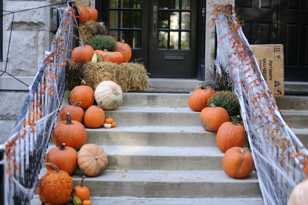 front porch steps lined with pumpkins